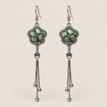 Jade Whisper floral tassel earrings, front view showing soft green floral embroidery in flower-shaped metal frames with three chain tassels with rounded drops.
