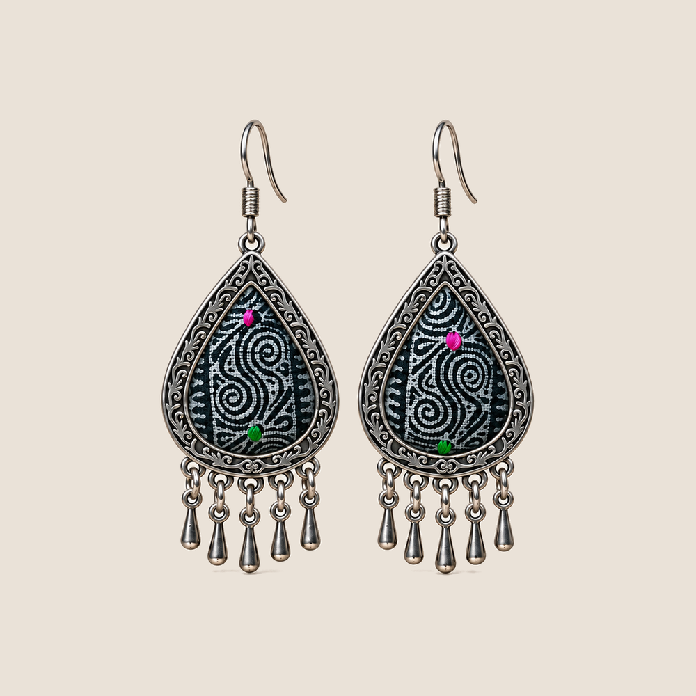 Midnight Currents batik teardrop earrings with pale spirals on dark textile, pink and green accents and five short drops.