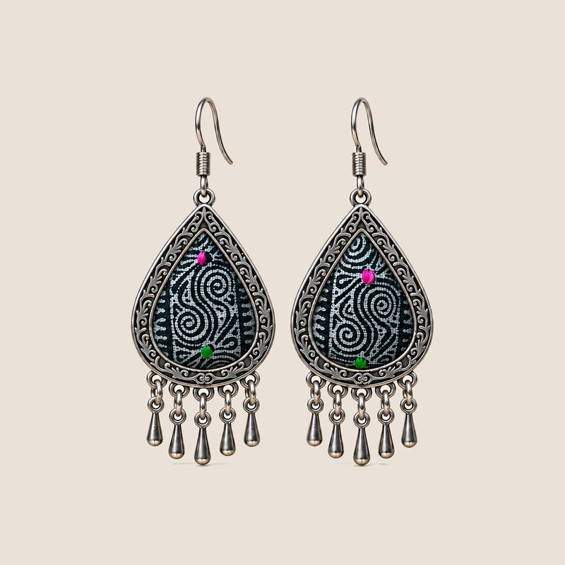 Midnight Currents batik teardrop earrings with pale spirals on dark textile, pink and green accents and five short drops.
