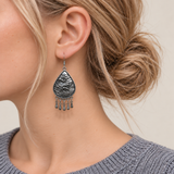 Close-up of a Midnight Currents earring worn with its sculpted wave-relief reverse facing outward.