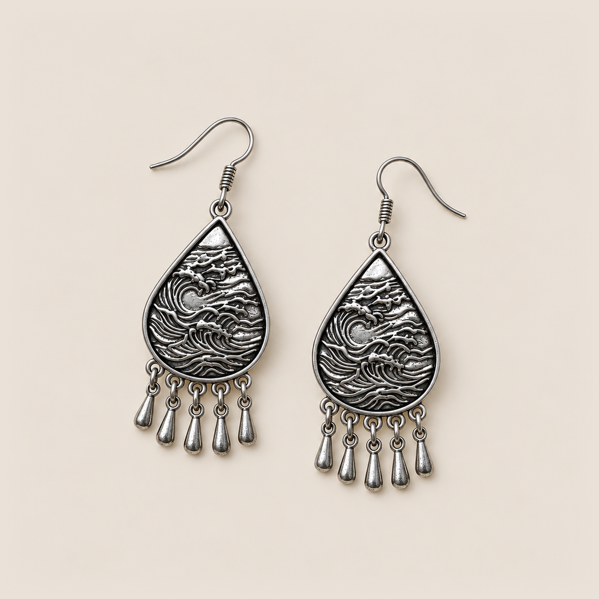 Midnight Currents earrings lying flat with wave-relief metal backs and five short drops visible.