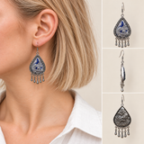 Silver Tide earring worn with the embroidered front facing outward, beside front, side and reverse views.