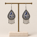 Silver Tide earrings hanging from a display stand with their embroidered fronts facing forward.