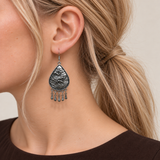 Close-up of a Verdant Reverie earring worn with the sculpted wave-relief metal reverse facing outward.