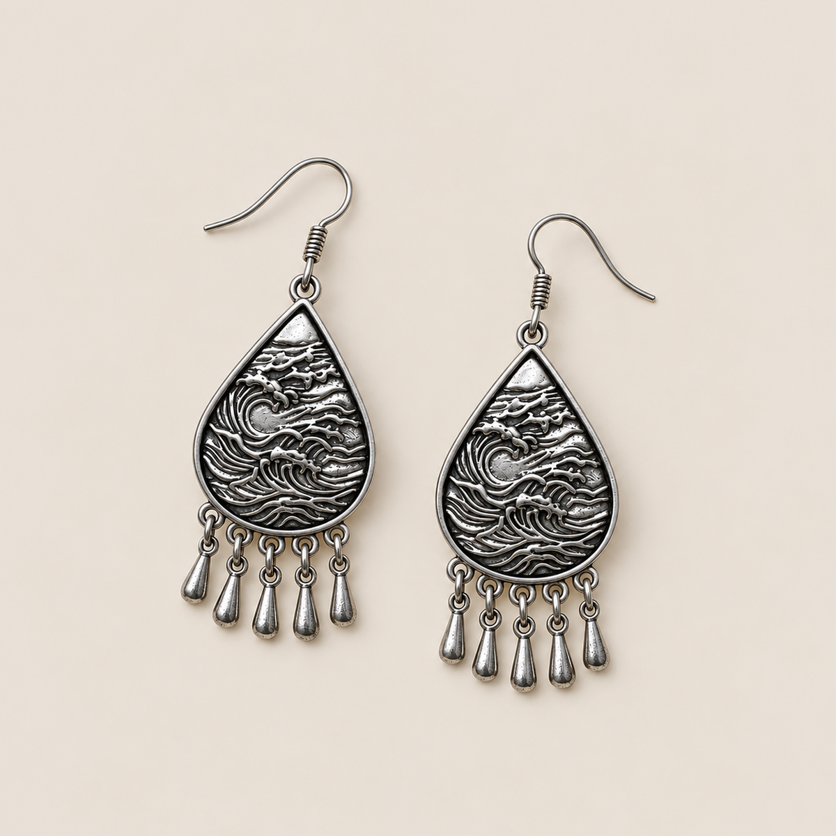 Verdant Reverie earrings laid flat with wave-relief backs facing up and five short drops beneath each teardrop.