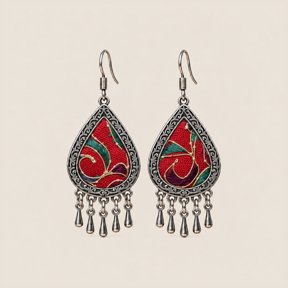 Crimson Aurora teardrop earrings with red horsehair embroidery, green and purple accents, pale curved lines and five short drops.