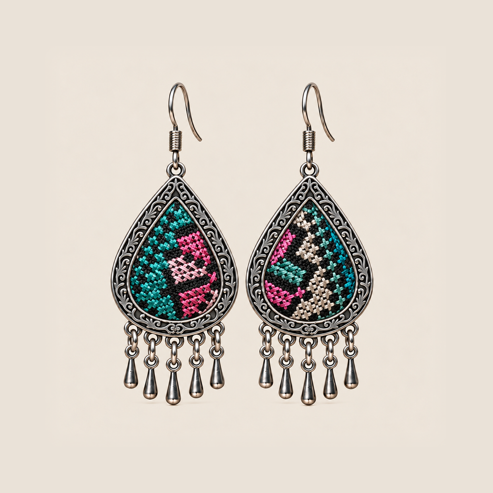 Twilight Mosaic teardrop earrings with differing teal, pink and pale counted-thread embroidery on black textile and five short drops.