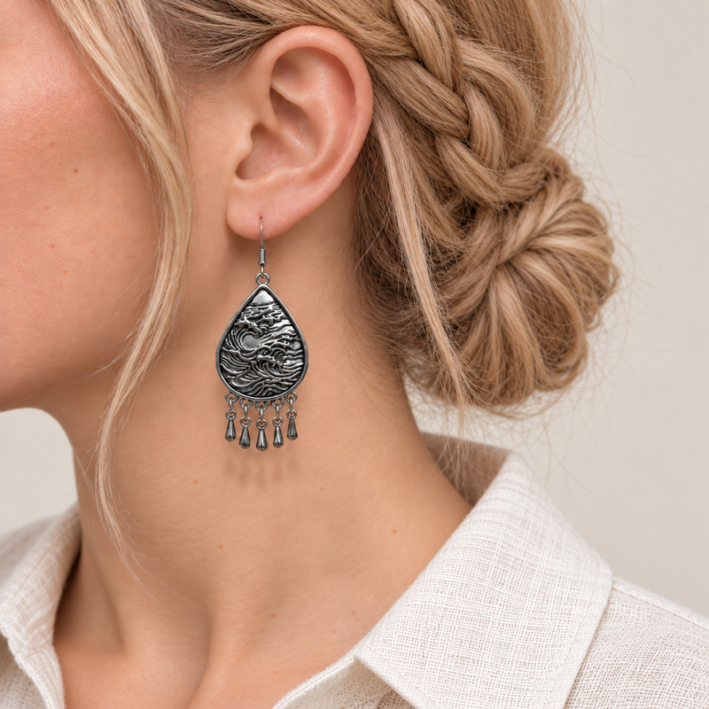 Close-up of a Twilight Mosaic earring worn with its sculpted wave-relief metal reverse facing outward.