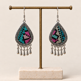 Twilight Mosaic embroidered teardrop earrings hanging from a T-bar stand, with differing geometric patterns and five short drops each.