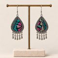 Twilight Mosaic embroidered teardrop earrings hanging from a T-bar stand, with differing geometric patterns and five short drops each.