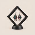 Twilight Mosaic earrings displayed inside a transparent, diamond-oriented black frame on a black base.