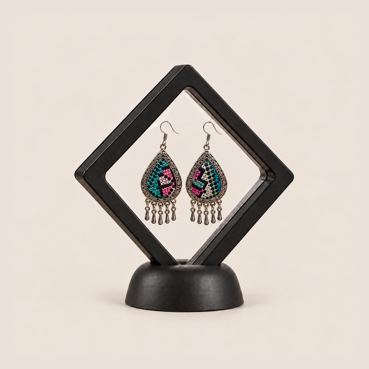 Twilight Mosaic earrings displayed inside a transparent, diamond-oriented black frame on a black base.