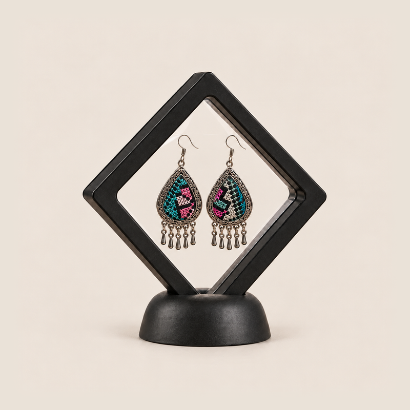 Twilight Mosaic earrings displayed inside a transparent, diamond-oriented black frame on a black base.