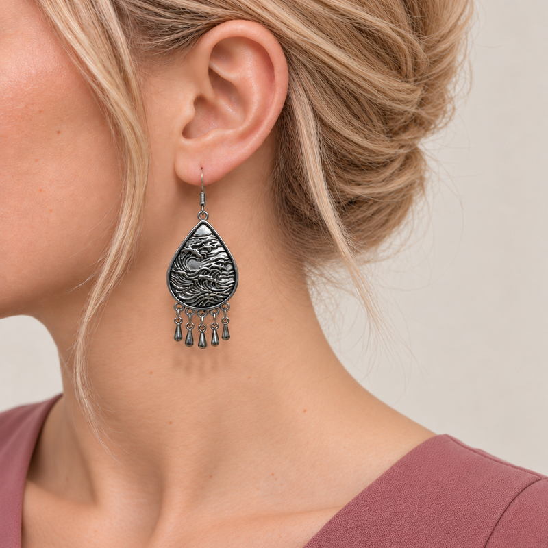 Close-up of a Lavender Sonata earring worn with its sculpted wave-relief metal reverse facing outward.