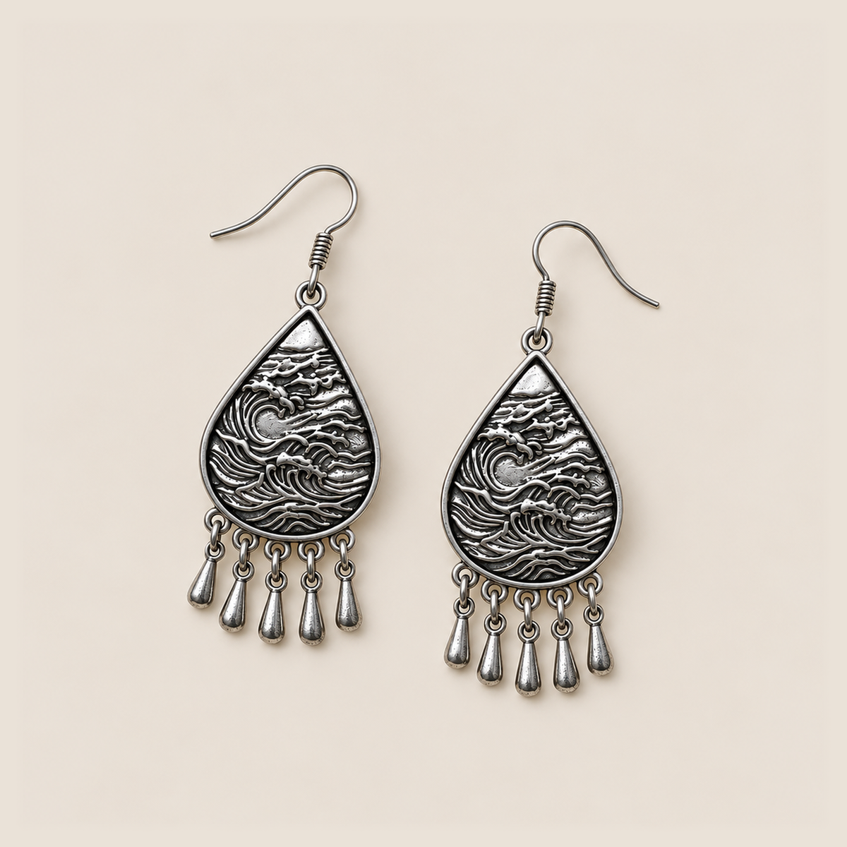 Lavender Sonata earrings laid flat with wave-relief backs facing up and five short drops beneath each teardrop.