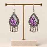 Lavender Sonata floral teardrop earrings hanging from a T-bar stand, with purple embroidered petals and five short drops each.