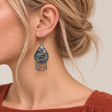 Close-up of a Blush Reverie earring worn with its sculpted wave-relief reverse facing outward.