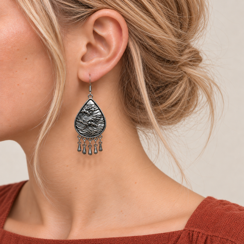 Close-up of a Blush Reverie earring worn with its sculpted wave-relief reverse facing outward.