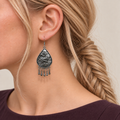 Close-up of a Prismatic Reverie earring worn with its sculpted wave-relief reverse facing outward.