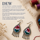 Prismatic Reverie earrings beside colorful thread spools, woven cloth and dried flowers in the Little knots, lasting colour story panel.