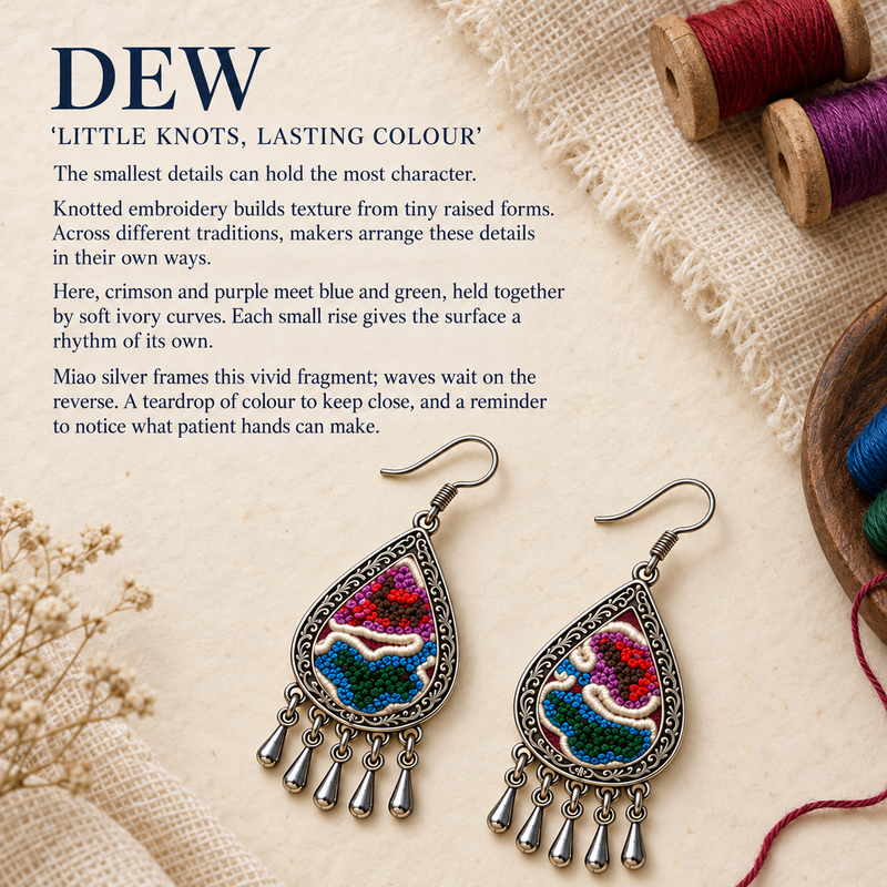 Prismatic Reverie earrings beside colorful thread spools, woven cloth and dried flowers in the Little knots, lasting colour story panel.