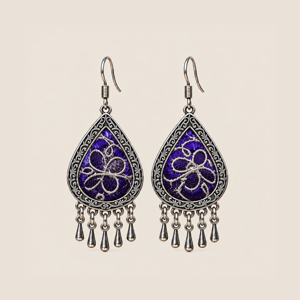 Violet Arabesque teardrop earrings with silver-white Panjin embroidery curves on purple textile and five short drops.