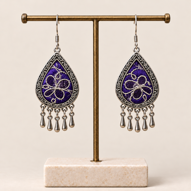 Violet Arabesque Panjin embroidery earrings hanging from a T-bar stand with five short drops beneath each teardrop.