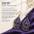 Violet Arabesque earrings on purple cloth beside cream paper and dried flowers in the Follow the quiet line story panel.