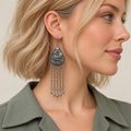 Model wearing a Burgundy Nocturne earring with its wave-relief reverse and five long chains with teardrop ends facing outward.