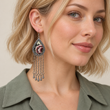 Model wearing a Burgundy Nocturne earring with burgundy and ivory floral embroidery above five long chains with teardrop ends.