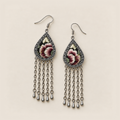 Burgundy Nocturne earrings lying face up, showing differing floral embroidery sections and pale green leaves on black.