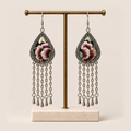 Burgundy Nocturne floral earrings hanging from a T-bar stand with five long chains and teardrop ends beneath each frame.