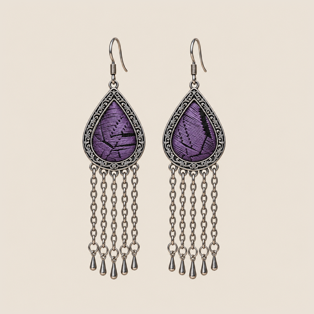 Amethyst Cadence counted-thread embroidery earrings with purple stitches, black geometric lines and five long chains with teardrop ends.