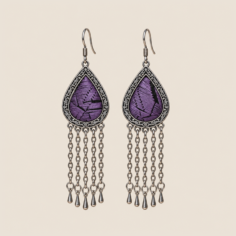 Amethyst Cadence counted-thread embroidery earrings with purple stitches, black geometric lines and five long chains with teardrop ends.