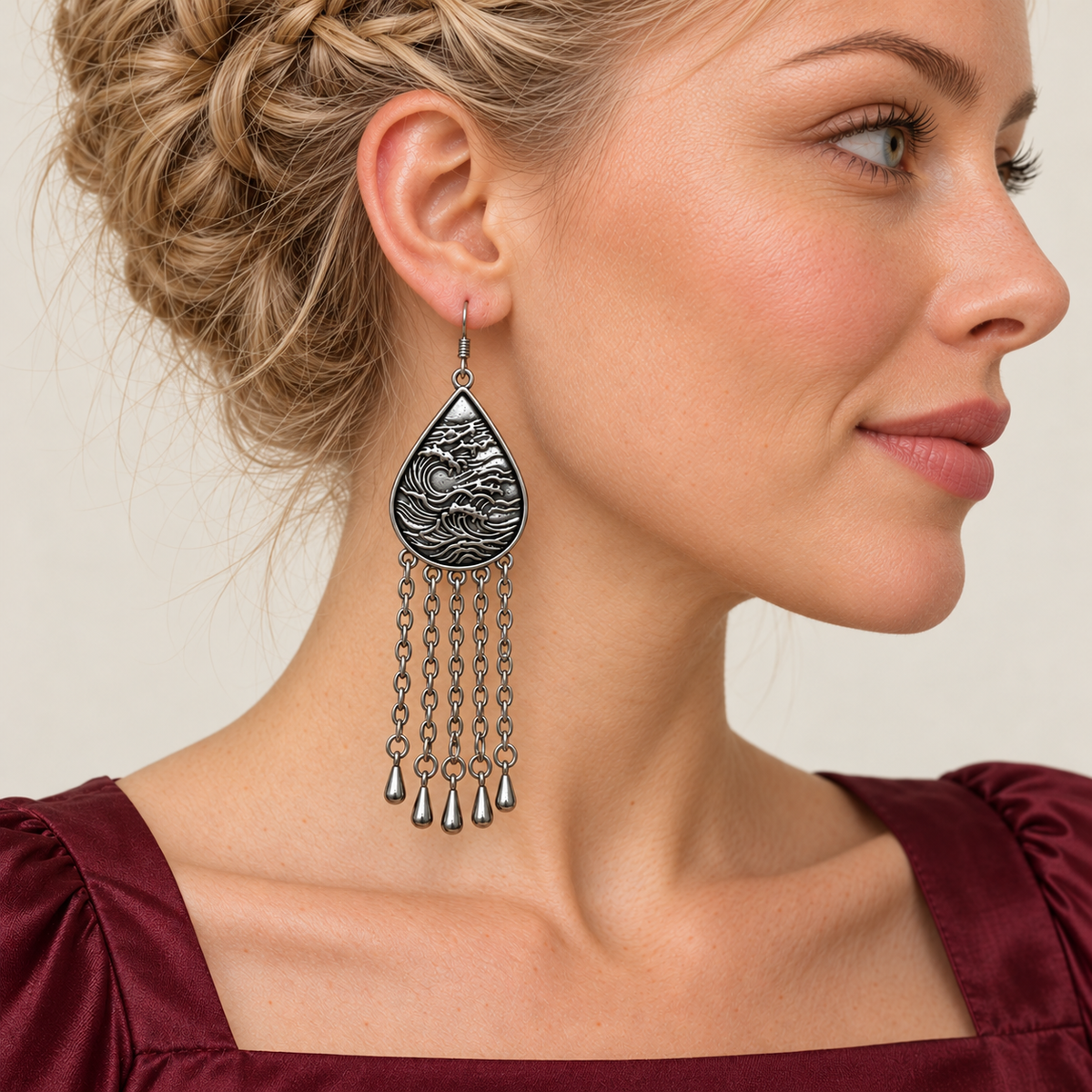 Model wearing an Amethyst Cadence earring with its wave-relief reverse facing outward above five long chains with teardrop ends.