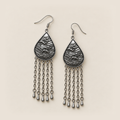 Amethyst Cadence earrings lying flat with wave-relief backs and five long chains ending in teardrop pendants on each earring.