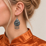 Close-up of a Fuchsia Tide earring worn with its sculpted wave-relief reverse facing outward.