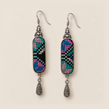 Front detail of Pastel Cadence earrings with different pink, teal, blue and pale counted-thread patterns on black textile.