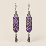 Violet Luminance Panjin Embroidery earrings featuring purple stitching with pale looping outlines, with one engraved teardrop each.