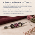 Suzhou Embroidery story card with a Petal Nocturne earring beside burgundy cloth, pink and olive thread and dried flowers.