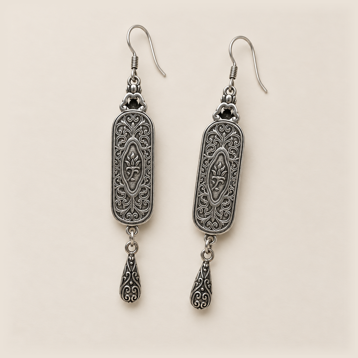 Back view of Emerald Reverie earrings with scrollwork, central oval motifs, openwork tops and engraved teardrops.