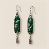 Front detail of Emerald Reverie earrings showing different pale leaf-like patterns woven into green textile panels.