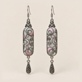 Pastel Arabesque Panjin Embroidery earrings with pale pink and green fills, looping outlines on light gray textile and one teardrop each.