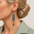 Blossom Serenade earring worn with the sculpted scrollwork reverse, central oval motif and engraved teardrop facing outward.