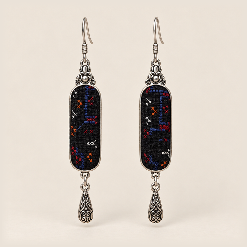 Ember Constellation Counted-Thread Embroidery earrings with navy, red, orange and white stitches on black panels and engraved drops.