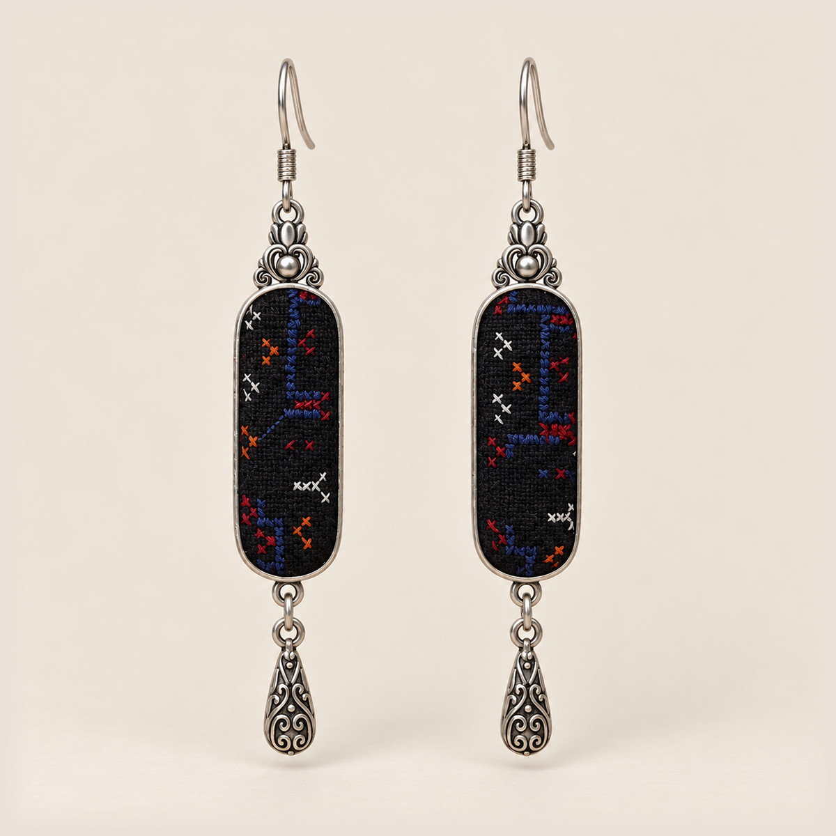 Ember Constellation Counted-Thread Embroidery earrings with navy, red, orange and white stitches on black panels and engraved drops.