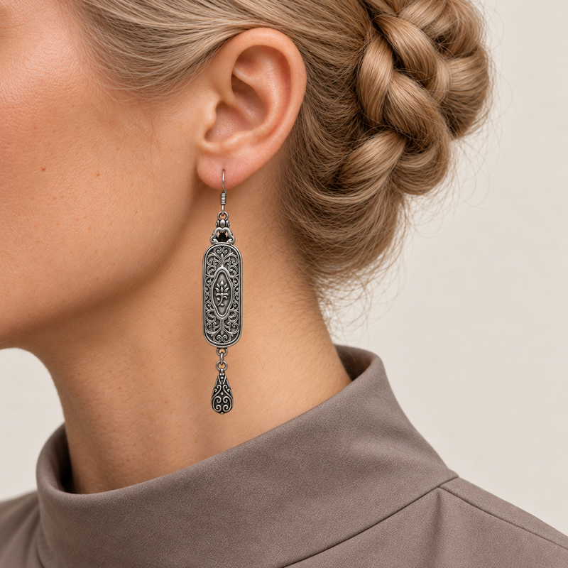 Ember Constellation earring worn with the sculpted scrollwork reverse, central oval motif and engraved teardrop facing outward.