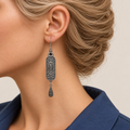Autumn Sonata earring worn with the sculpted scrollwork reverse, central oval motif and engraved teardrop facing outward.
