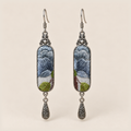 Blue Reverie Suzhou Embroidery earrings with layered blue-gray petals and green leaves on pale gray panels, each with an engraved drop.