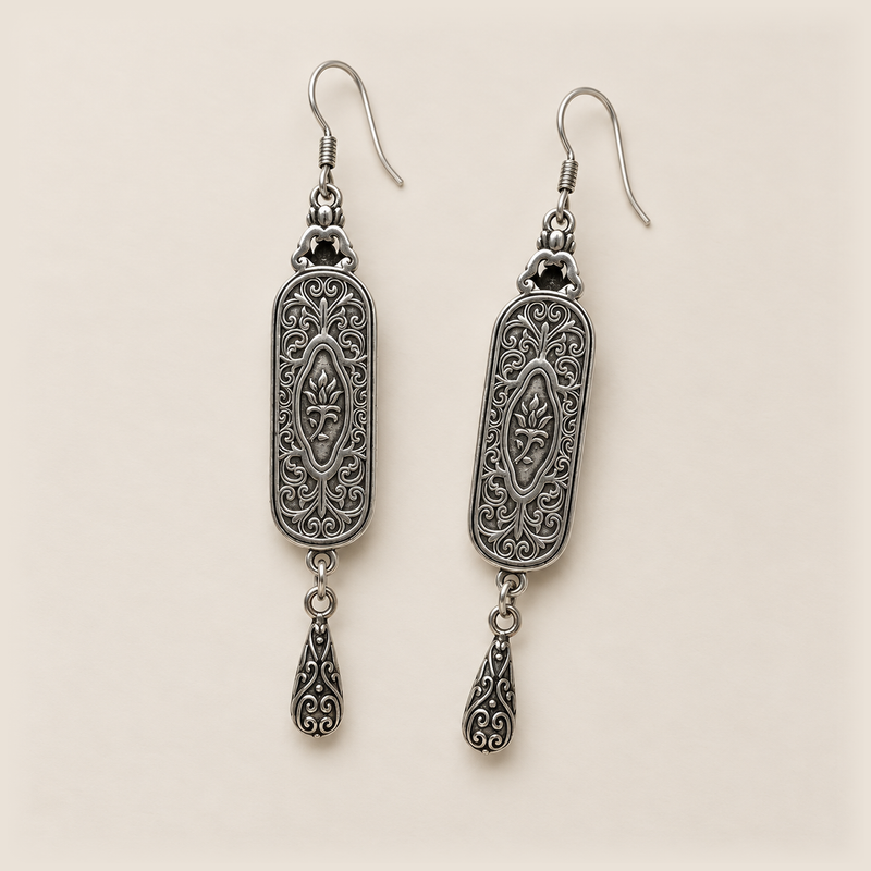Reverse of the Blue Reverie pair, showing curled metal relief, central oval motifs and one engraved teardrop per earring.